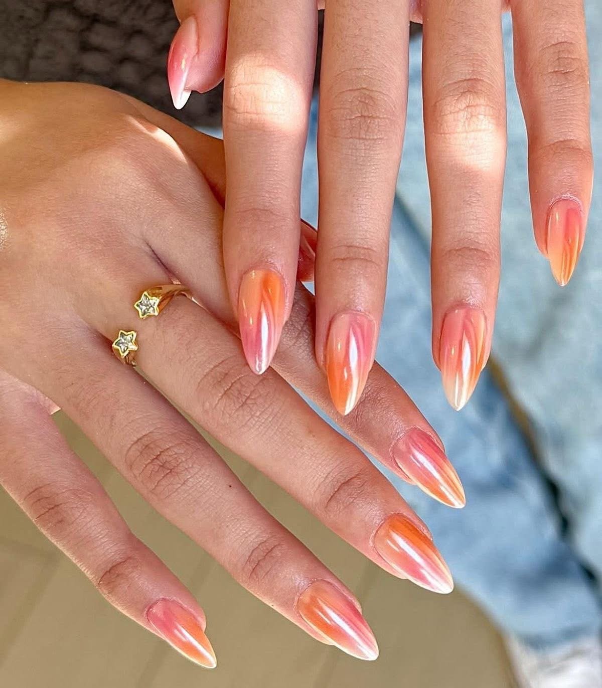 Sunset glazed nails in orange and pink pearl almond shape